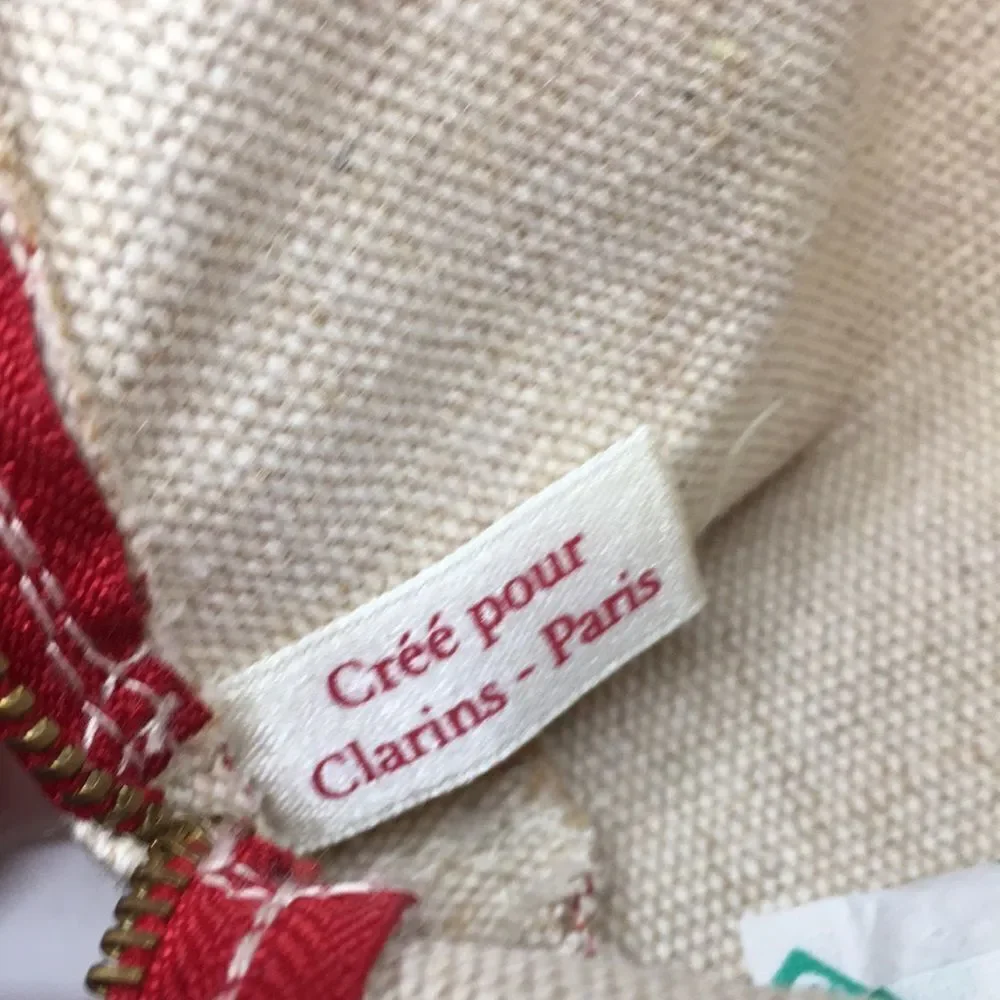 FEED 10 Clarins makeup cosmetics light tan and red carry-all pouch